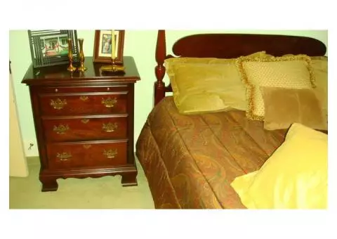 Full bed with turned spindles, curved headboard, pine cone post tops